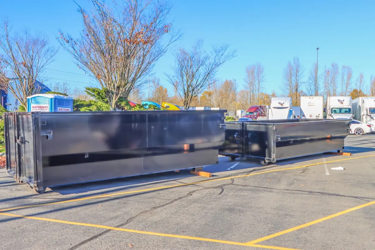 Professional dumpster rental service with roll-off container on residential driveway in West Haverstraw